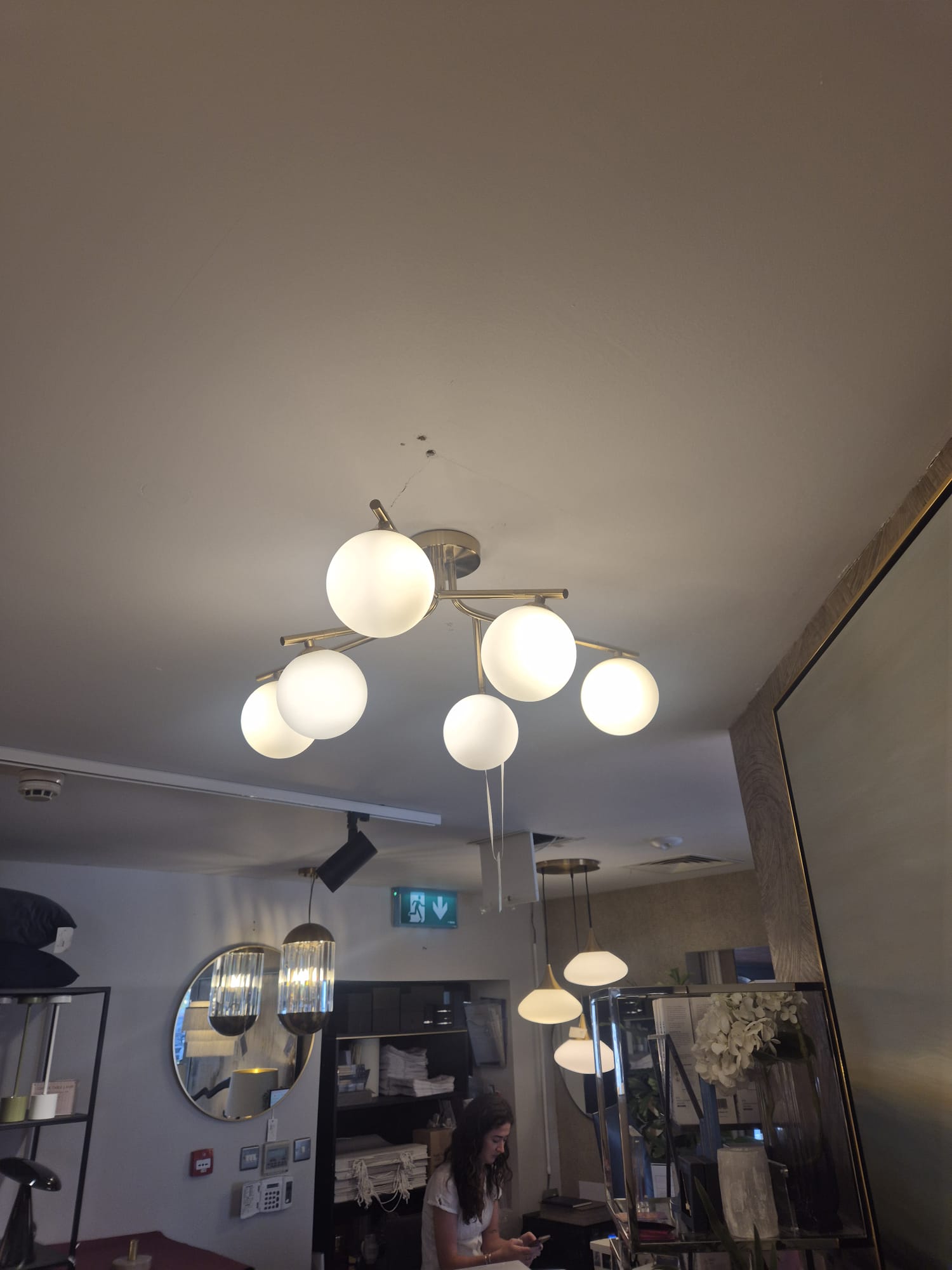 Multi-globe ceiling fitting installed and lamped.