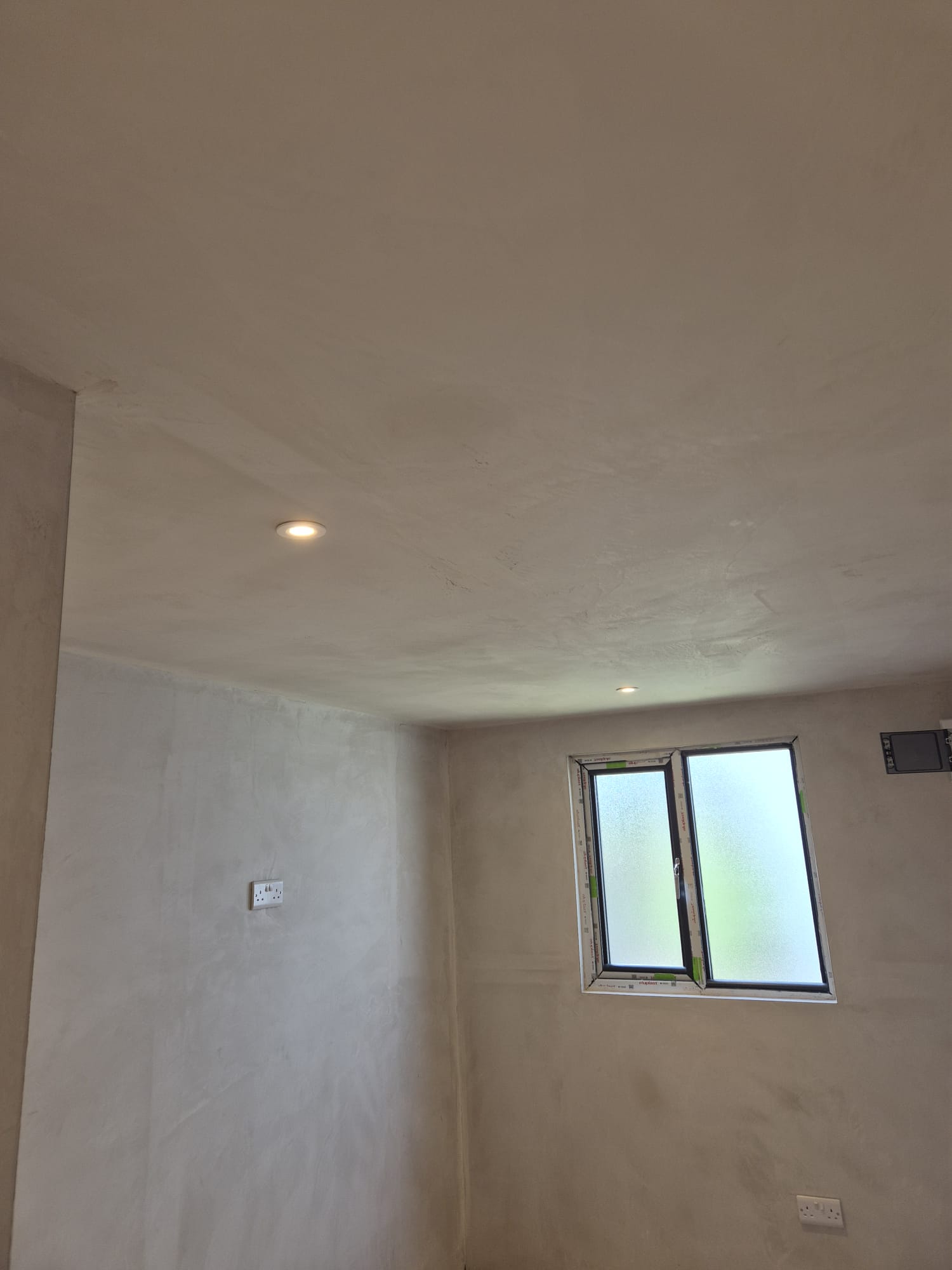 Downlights and sockets in after a freshly plastered room.