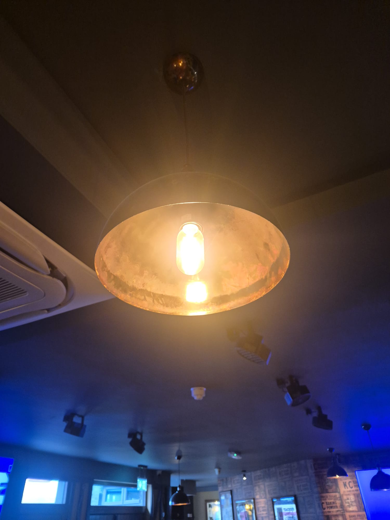 Dome pendant hung and levelled in a bar ceiling.